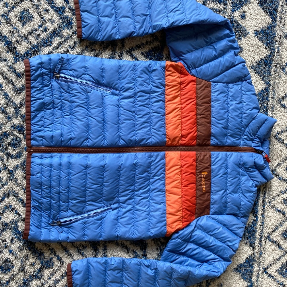 Cotopaxi Kids Jacket in Blue with Orange and Brown Accents